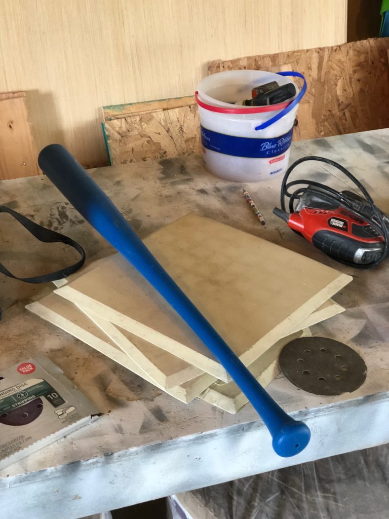 blue baseball bat with bases and sander