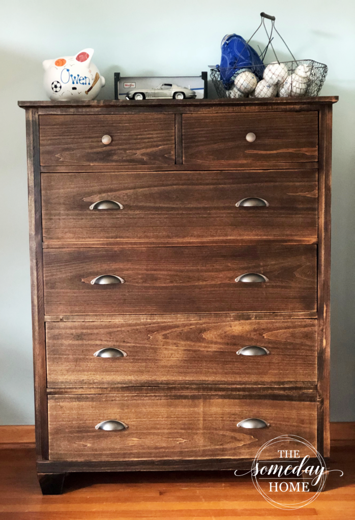 dresser with piggy bank and baseballs