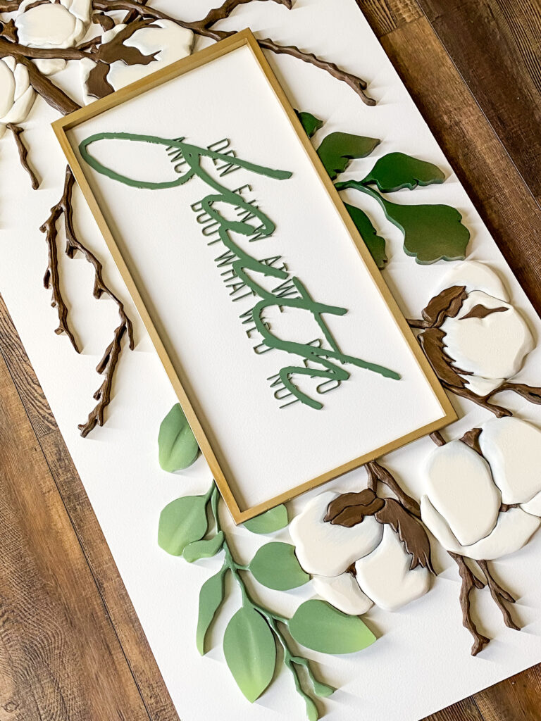Sign with cotton bolls and eucalyptus leaves.