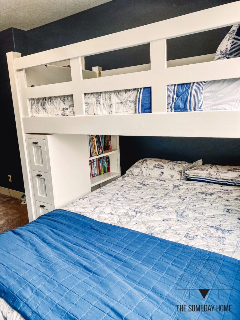 View of a white loft bed with queen sized bed underneath it