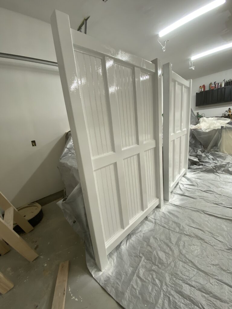 Two ends of a loft bed. Painted white.