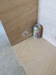 Plywood box with can of peach la croix in it